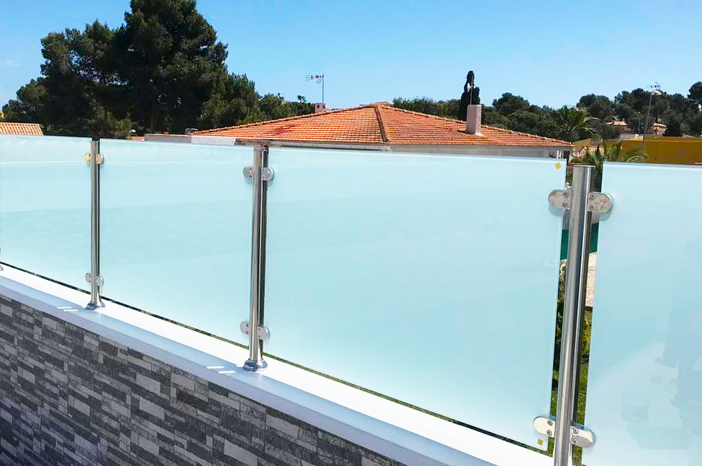 Frosted balustrades installed on brick wall creating privacy between overlooking properties.